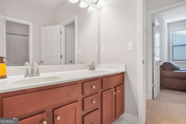 bathroom featuring double vanity, baseboards, and a sink