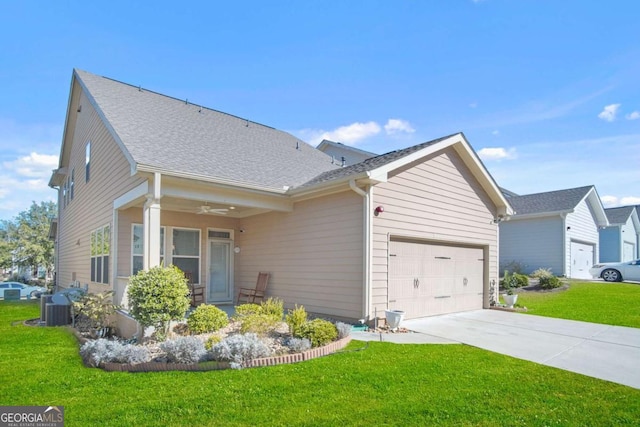 view of front of house featuring central air condition unit, a ceiling fan, a front lawn, concrete driveway, and a garage