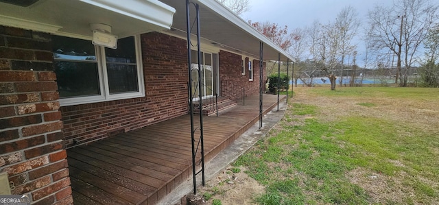 view of side of property featuring brick siding and a water view