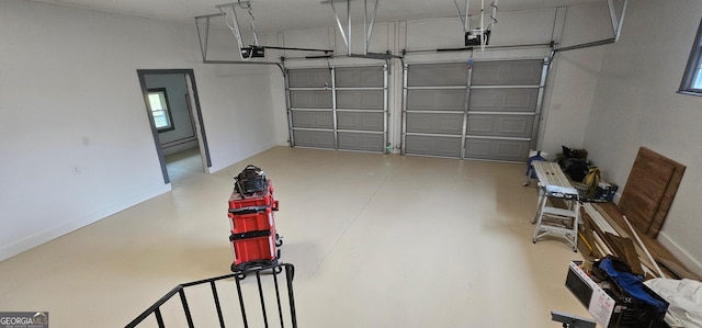 garage featuring a garage door opener and baseboards