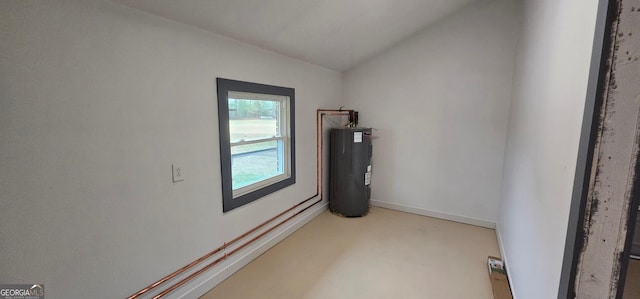 spare room featuring baseboards, lofted ceiling, and water heater