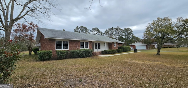 ranch-style home with brick siding and a front lawn