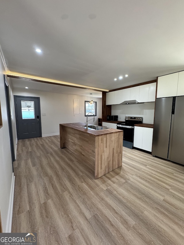 kitchen with white cabinets, stainless steel appliances, modern cabinets, and a sink