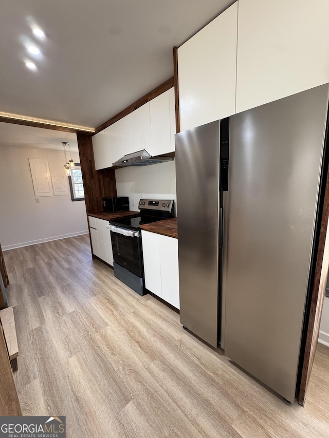 kitchen with light wood finished floors, butcher block countertops, stainless steel appliances, white cabinetry, and modern cabinets