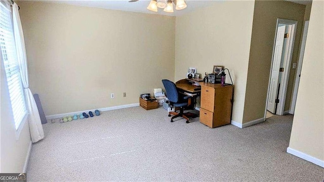 carpeted office with plenty of natural light and baseboards