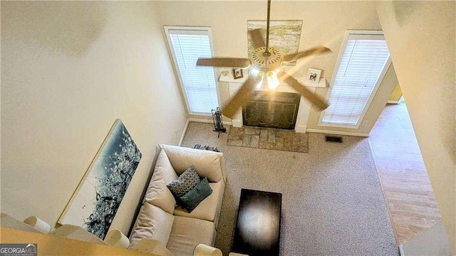 interior space with visible vents, baseboards, and a ceiling fan