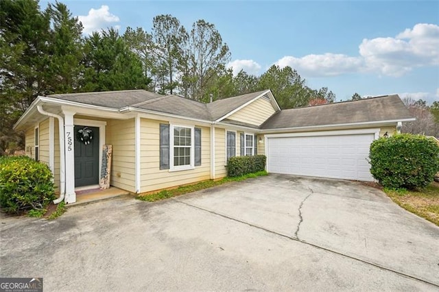 single story home with an attached garage and concrete driveway