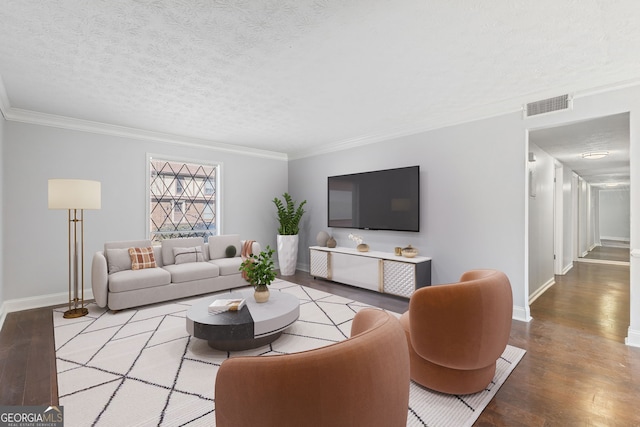 living area with visible vents, a textured ceiling, crown molding, and wood finished floors