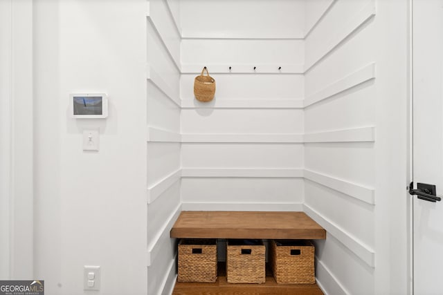 mudroom with wood finished floors and baseboards