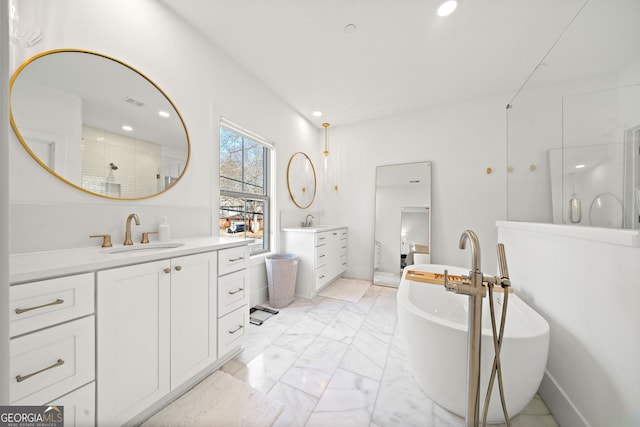 bathroom with marble finish floor, a walk in shower, two vanities, and a sink