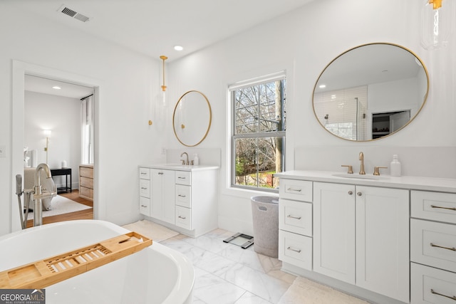 bathroom with visible vents, two vanities, recessed lighting, a sink, and marble finish floor