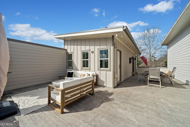 view of patio with an outdoor living space, a wooden deck, and outdoor dining space