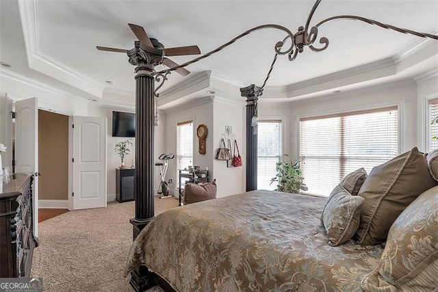 bedroom featuring a tray ceiling, ornamental molding, and carpet flooring