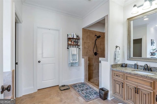 full bathroom featuring vanity, crown molding, baseboards, and tiled shower