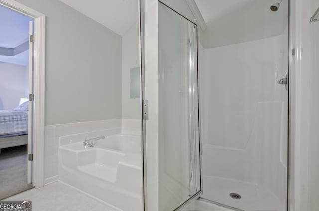 ensuite bathroom with a bath, ensuite bath, a shower stall, and vaulted ceiling