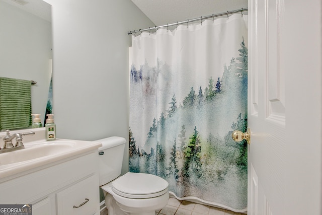 bathroom with tile patterned floors, a shower with curtain, toilet, and vanity