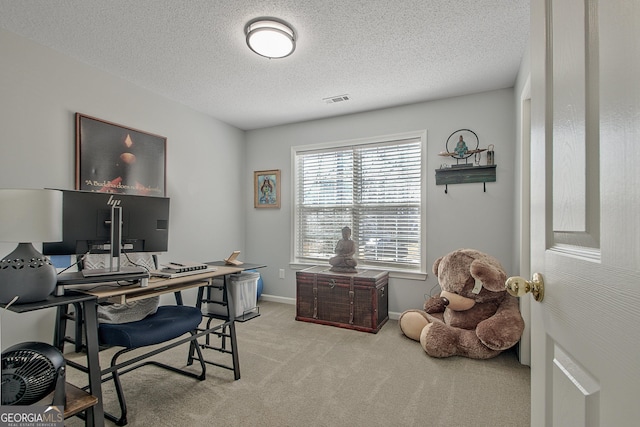 carpeted office space with visible vents, a textured ceiling, and baseboards