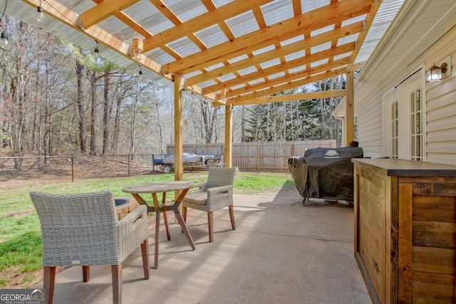 view of patio with outdoor dining area, area for grilling, a fenced backyard, and a pergola