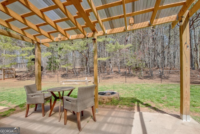 view of patio with outdoor dining space, a fire pit, a pergola, and a fenced backyard