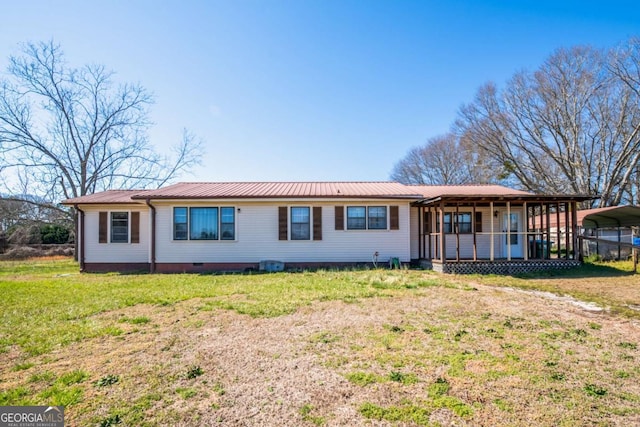 view of front facade featuring crawl space, a detached carport, metal roof, and a front yard