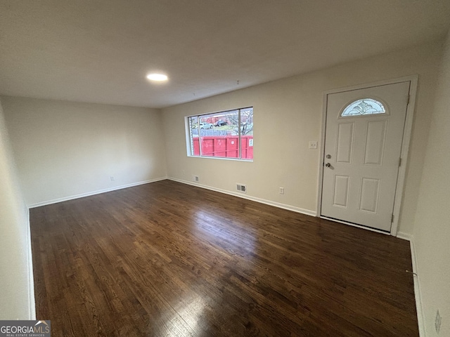 entryway with visible vents, baseboards, and dark wood-style flooring