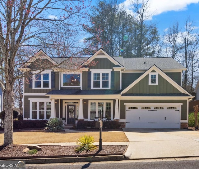 craftsman house with an attached garage, board and batten siding, and driveway