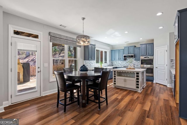 dining area featuring visible vents, dark wood-type flooring, baseboards, recessed lighting, and an inviting chandelier