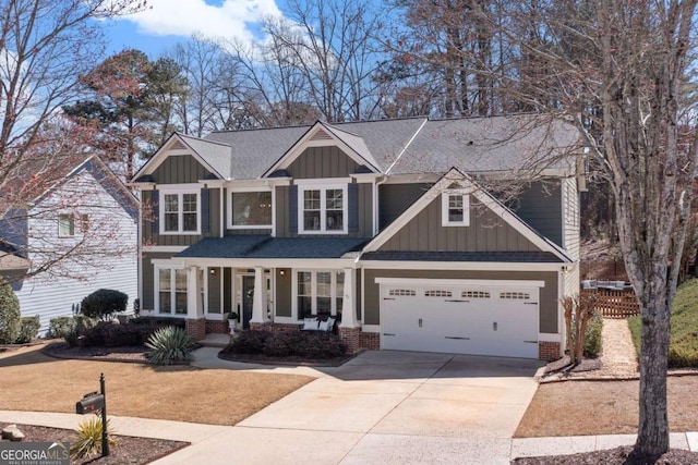 craftsman inspired home with concrete driveway, a garage, board and batten siding, and roof with shingles