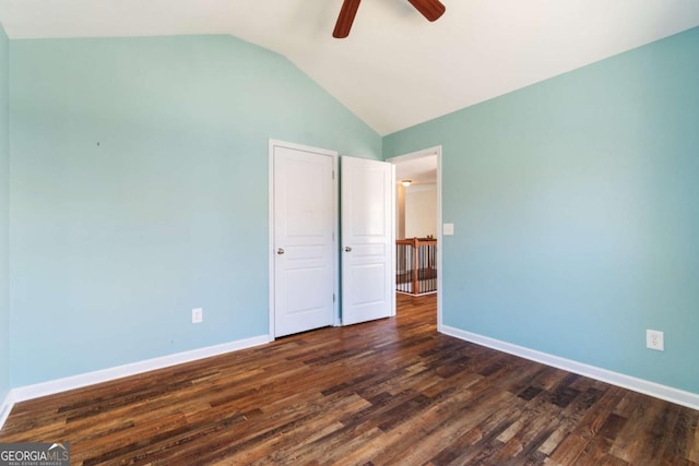 unfurnished bedroom with vaulted ceiling, baseboards, dark wood-style flooring, and ceiling fan