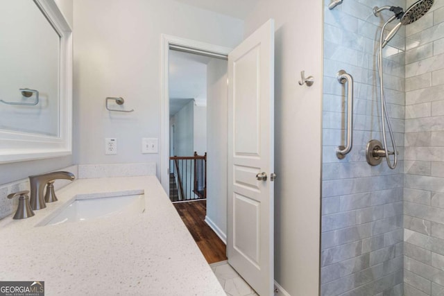 bathroom featuring vanity and a tile shower