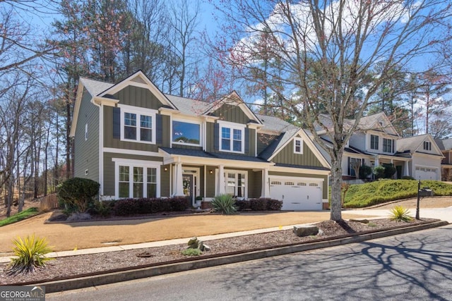 craftsman-style home with a garage, board and batten siding, and driveway