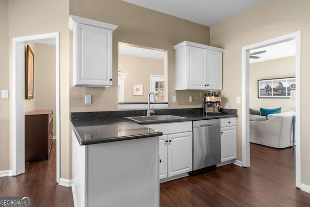 kitchen with dark wood-style floors, white cabinets, dishwasher, and a sink