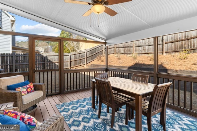 sunroom with lofted ceiling and a ceiling fan