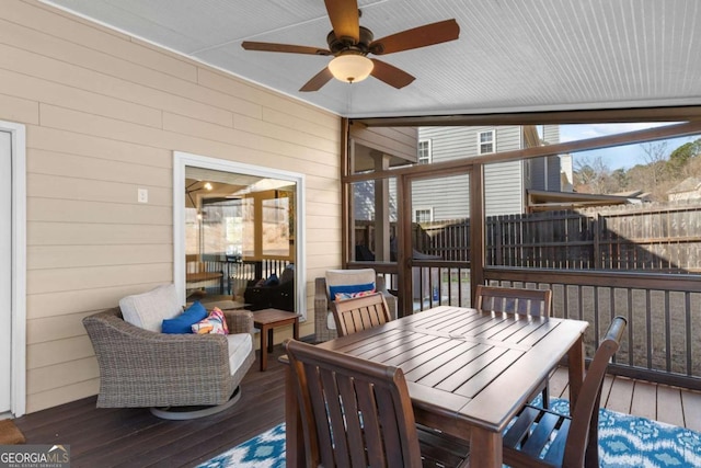 wooden terrace featuring outdoor dining area, ceiling fan, and fence