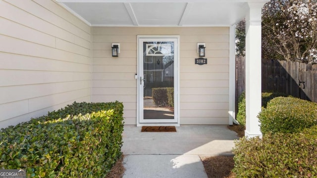 entrance to property featuring fence