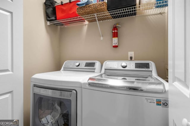 clothes washing area with laundry area and washer and clothes dryer