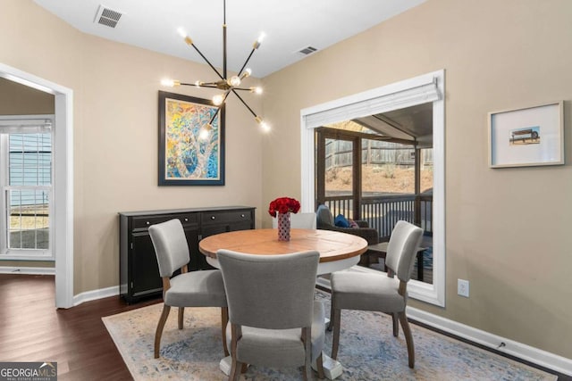 dining room featuring an inviting chandelier, baseboards, visible vents, and dark wood-type flooring