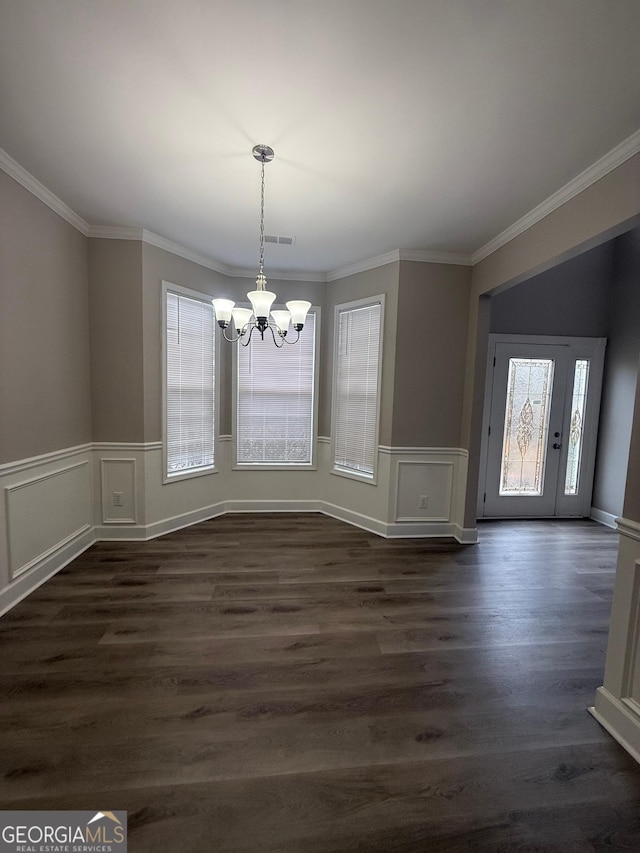 unfurnished dining area featuring a notable chandelier, ornamental molding, visible vents, and dark wood-style flooring