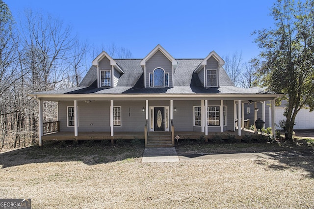 view of front of property featuring covered porch and a shingled roof