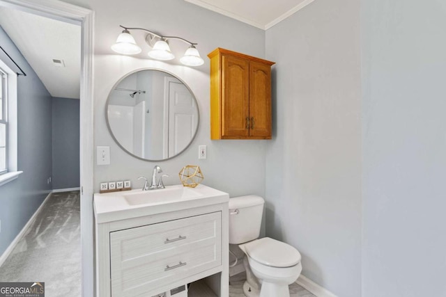 bathroom with crown molding, toilet, vanity, and baseboards