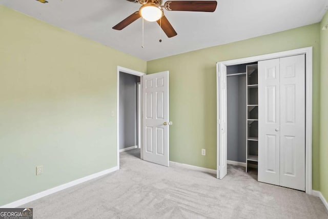 unfurnished bedroom with a closet, baseboards, carpet floors, and a ceiling fan