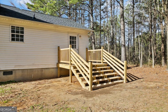 exterior space featuring crawl space and a shingled roof