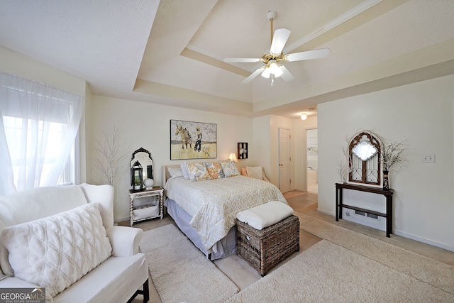 bedroom featuring a tray ceiling, a ceiling fan, baseboards, and light carpet