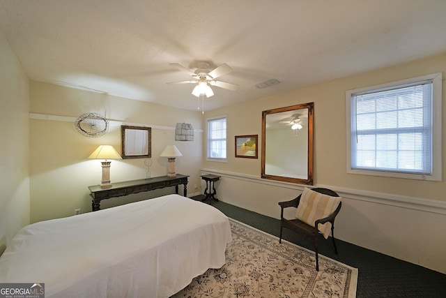 carpeted bedroom featuring visible vents and ceiling fan