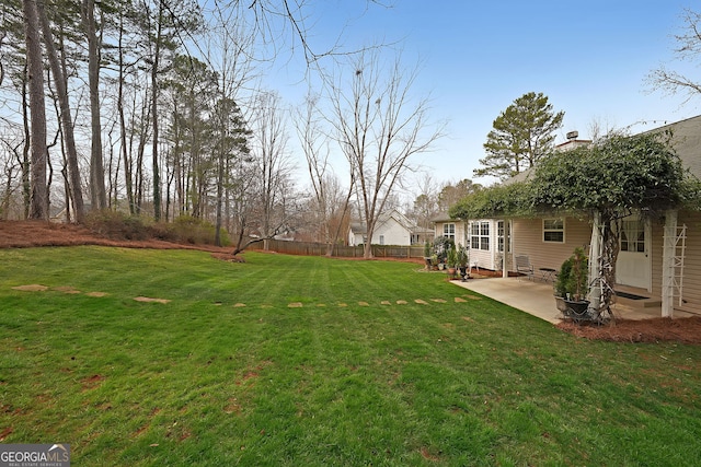 view of yard featuring a patio area, entry steps, and fence