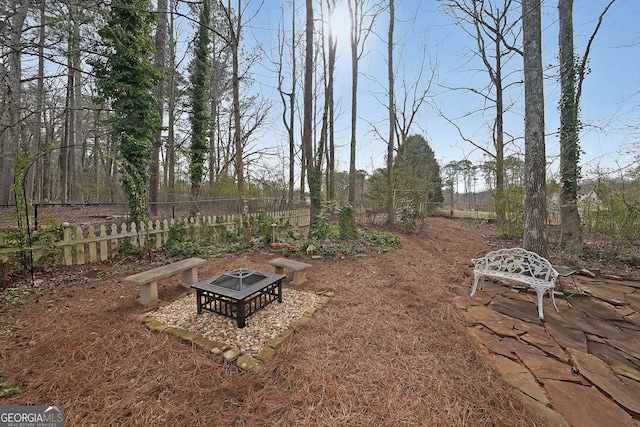 view of yard featuring a fire pit and fence