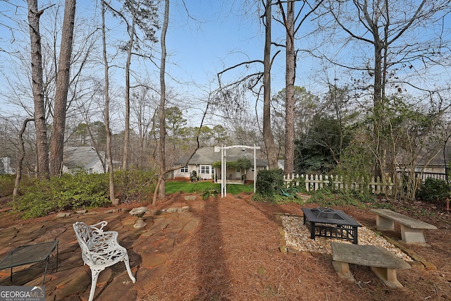 view of yard featuring a fire pit and fence