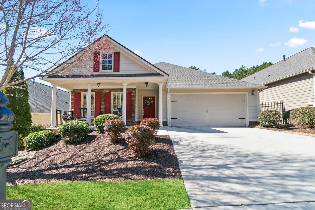 172 Summit Trl, Dallas, GA 30132 - view of front of property featuring a porch, concrete driveway, and a garage