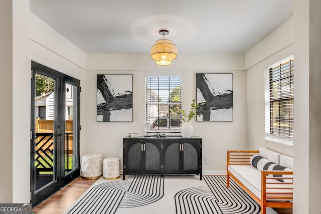 interior space with baseboards and wood finished floors