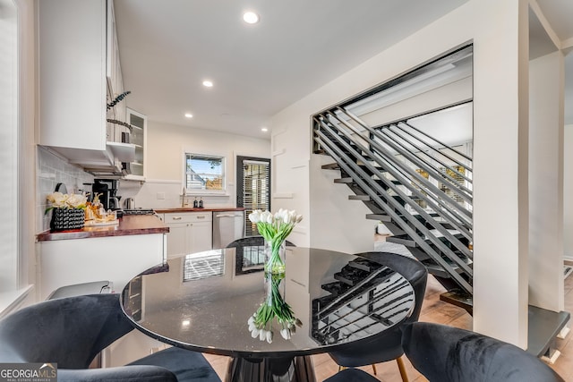 dining room with light wood-style flooring and recessed lighting